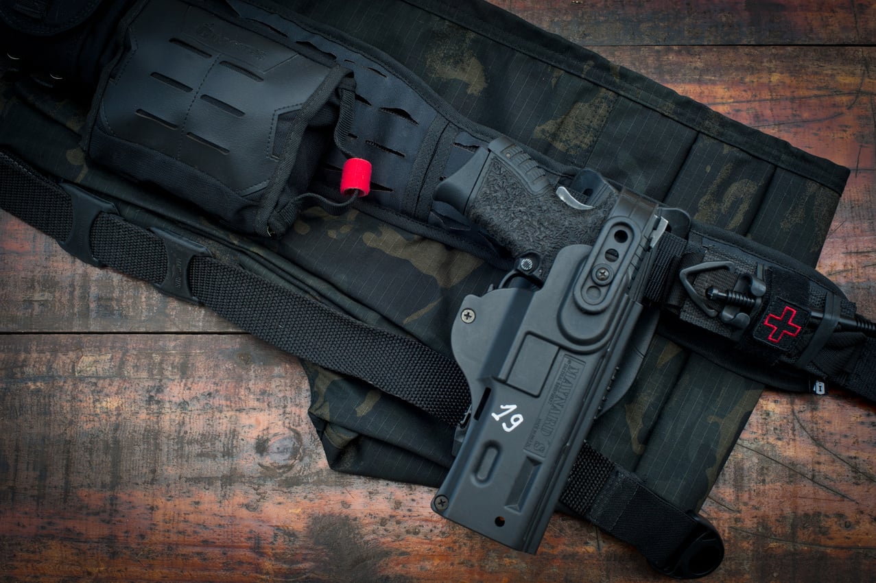 Top View of a Belt and Gun on a Wooden Floor